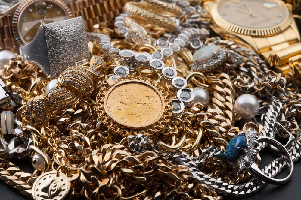 A big pile of gold, silver, pearls, coins, watches, and more.